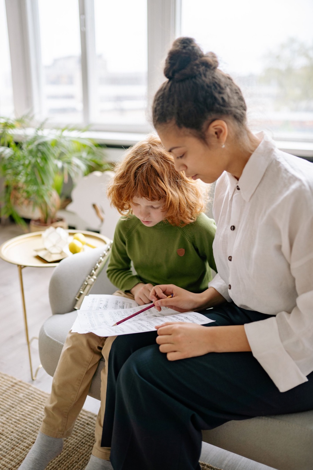 Teacher providing one-to-one academic support to a student